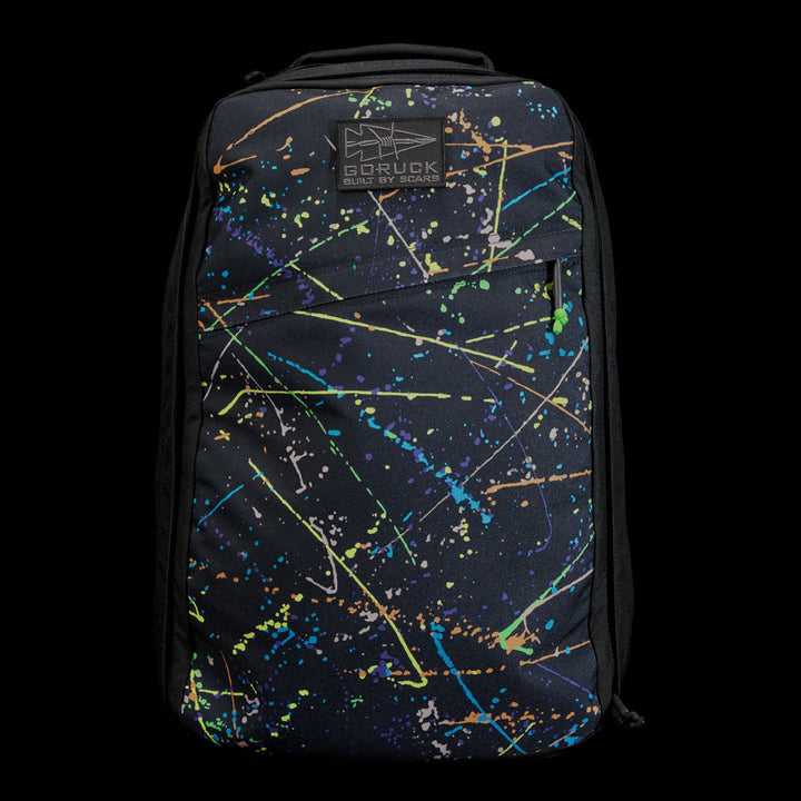 The GR1 Shooter 26L - Built by SCARS backpack features Special Forces Grade CORDURA®, a vibrant paint splatter design, and a "BORUCK BUILT BY SEAK" logo patch, inspired by the SCARS team's rigorous standards.
