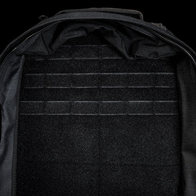 The open, empty GR1 Shooter 26L - Built by SCARS backpack features a velcro-lined interior with horizontal attachment strips, made from Special Forces Grade CORDURA®—perfect for any mission.