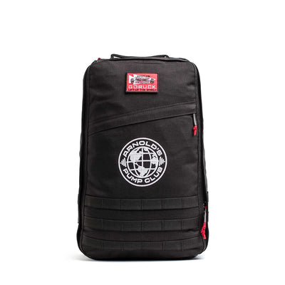 The 26L GR1 USA - GORUCK x Arnold's Pump Club features a black design with red zippers, a GORUCK patch, and the "Arnold's Pump Club" globe logo on the front. This limited-edition backpack is proudly built in the USA.