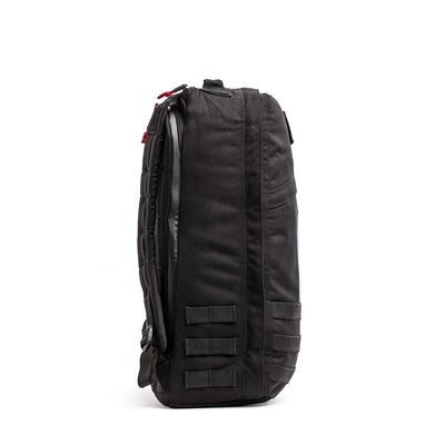The 26L GR1 USA - GORUCK x Arnold's Pump Club stands upright, side view shown with straps and webbing—this limited-edition backpack is proudly built in the USA.