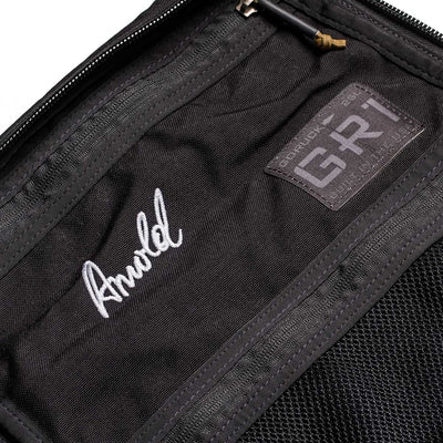 Close-up of the 26L GR1 USA - GORUCK x Arnold's Pump Club backpack with a stitched "Arnold" name and GORUCK patch inside, highlighting this limited-edition, built in USA rucksack.