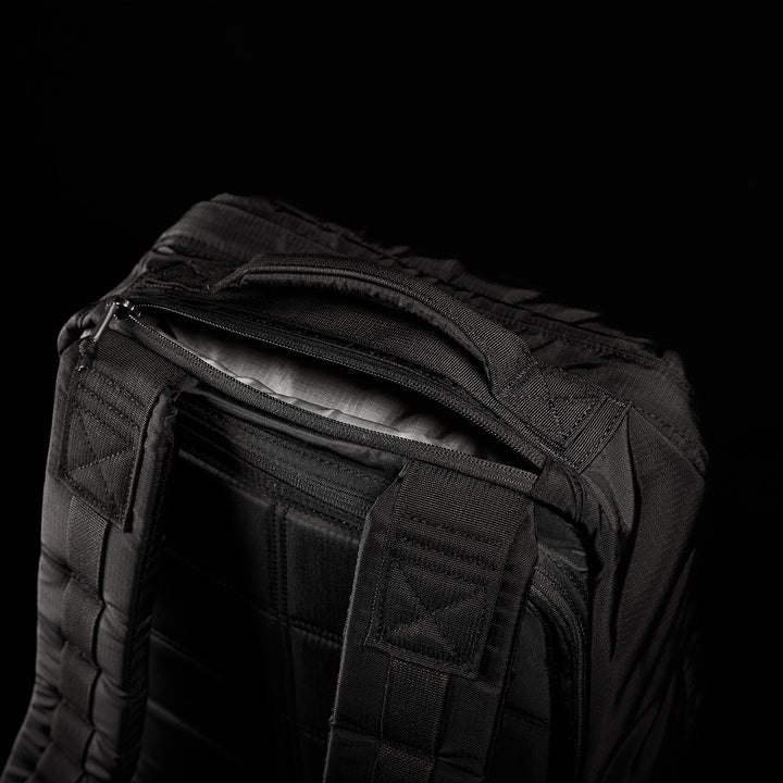 The GR1 USA - Ripstop ROBIC® is a black tactical backpack made from ultra-lightweight 420D Robic® Ripstop Nylon, featuring a rugged handle and stitching against a dark background.