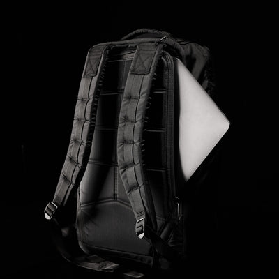 The GR1 USA - Ripstop ROBIC® backpack, crafted from ultra-lightweight 420D Robic® Ripstop Nylon, features padded straps and holds a partially visible laptop against a dark background.