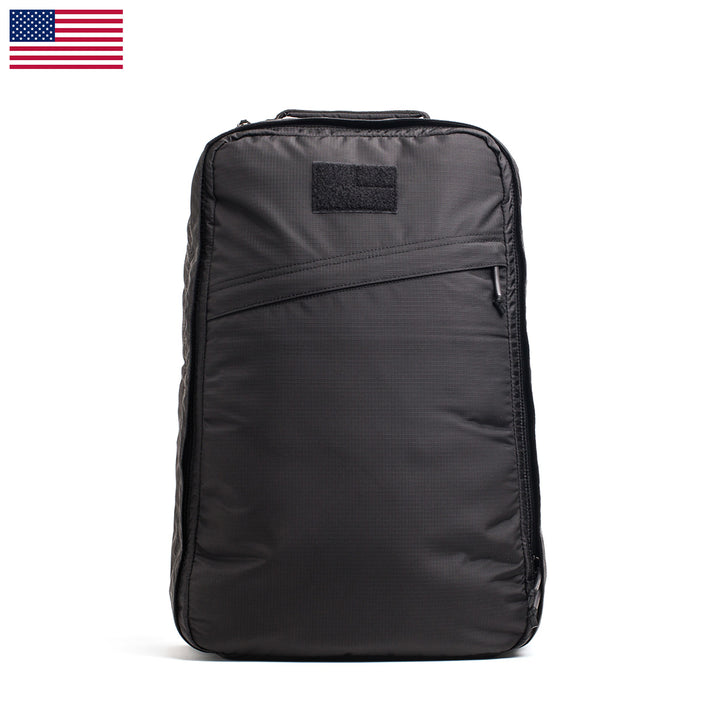 The GR1 USA - Ripstop ROBIC® is an ultra-lightweight, water-resistant black tactical backpack with a minimalist design. It features a small U.S. flag in the top left corner for a sleek look, making it perfect for any adventure.