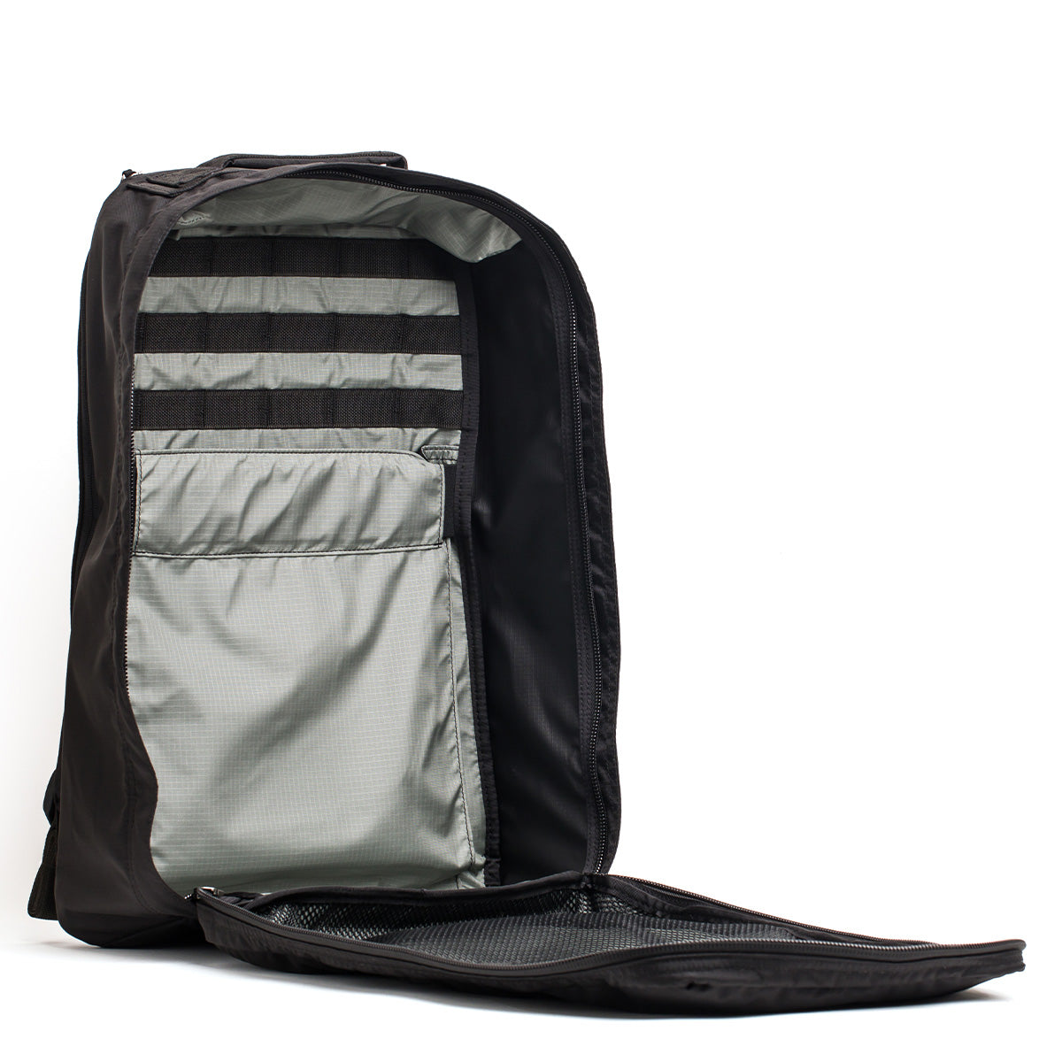 The GR1 USA - Ripstop ROBIC® black backpack, made from ultra lightweight 420D Robic Ripstop Nylon, reveals internal pockets and straps for organization when the front compartment is unzipped.