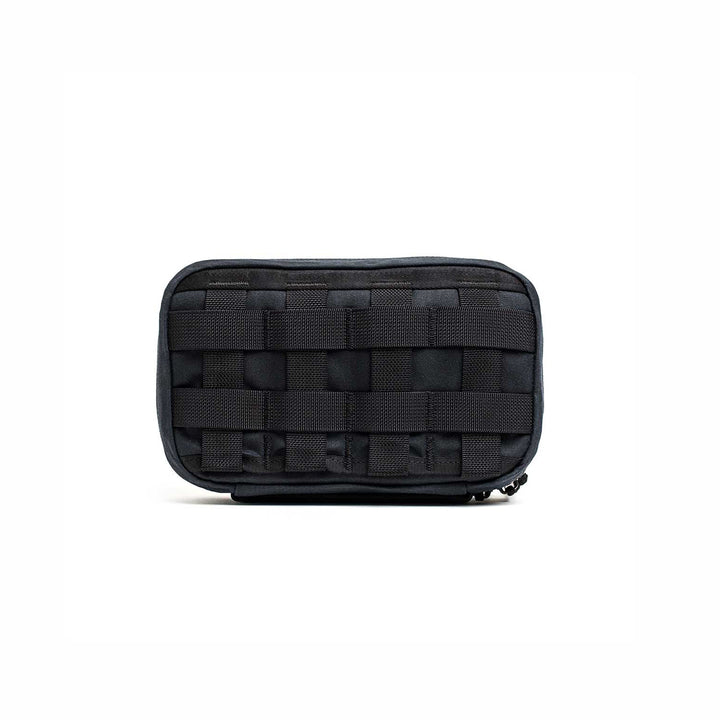 The GR1 Field Pocket - Waxed Canvas, a black tactical pouch with front MOLLE webbing, is displayed against a plain white background.
