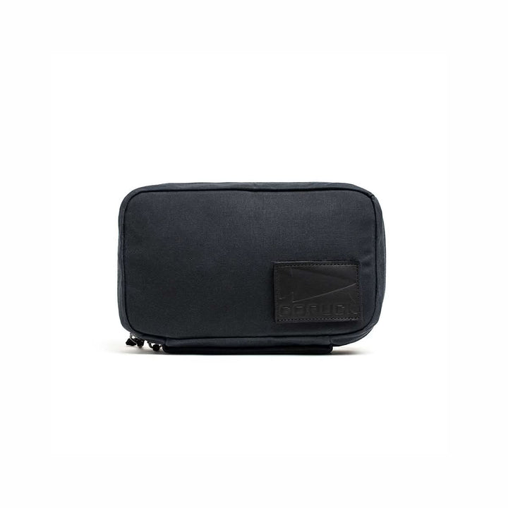 A compact black GR1 Field Pocket - Waxed Canvas with a stitched leather patch on the lower right corner, shown against a white background.