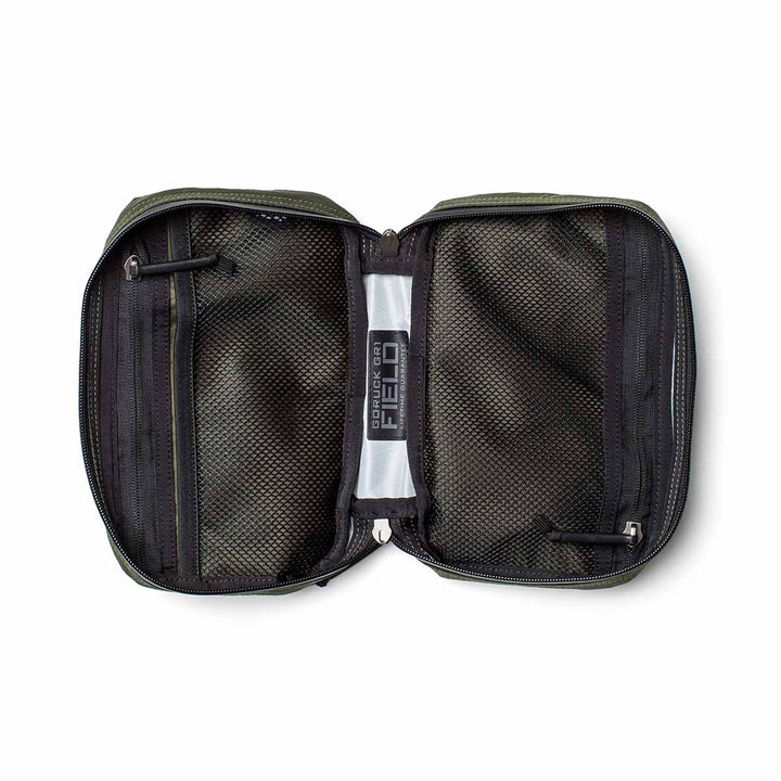 The GR1 Field Pocket - X-PAC is an open black mesh travel pouch made with waterproof X-PAC fabric, two AquaGuard zippered compartments, and a clear plastic center strip—ideal for organizing electronics.