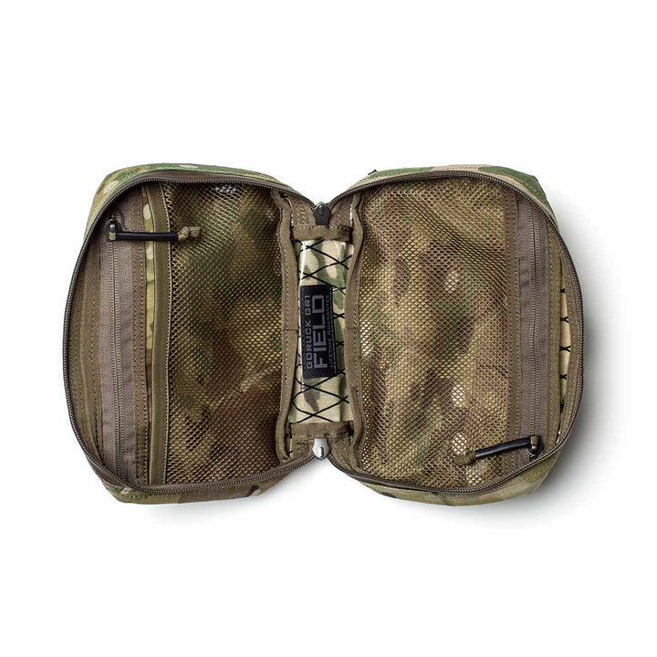 The GR1 Field Pocket - X-PAC features mesh zippered compartments and elastic straps in a camouflage, waterproof X-PAC build—perfect for use as an electronics organizer.