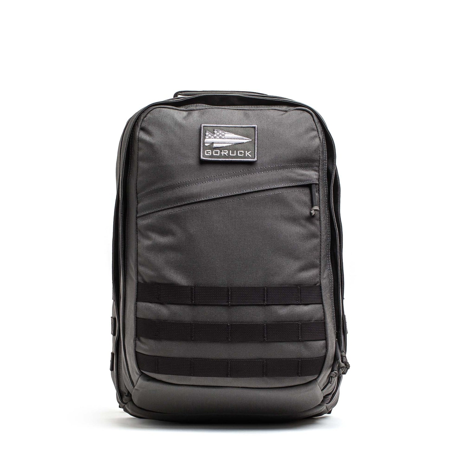 A black GR2 - Cordura ruck backpack with a front zipper pocket and horizontal webbing straps, designed for carry-on travel, is shown on a white background.