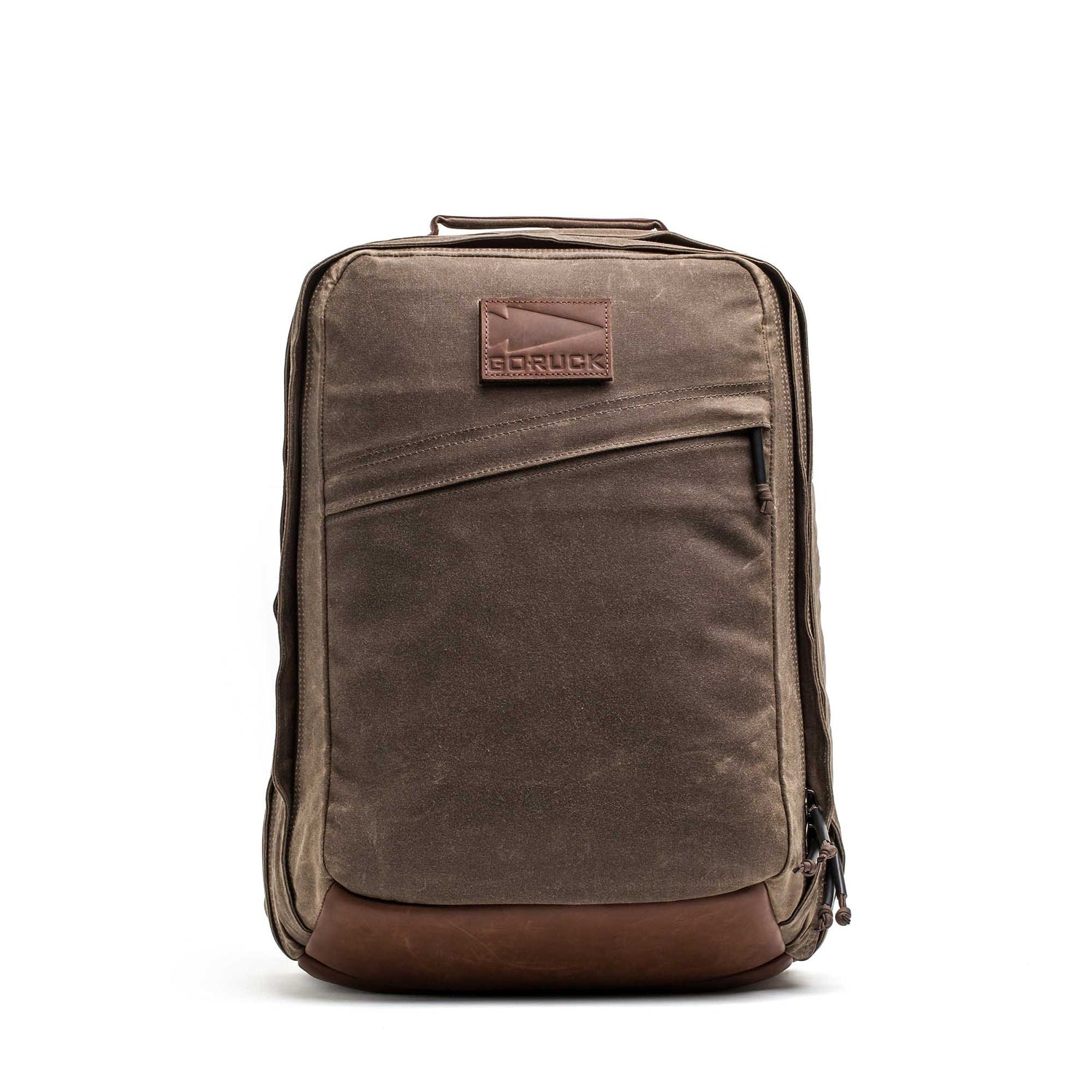 The GR2 - Heritage Waxed Canvas is a brown waxed canvas backpack with a leather bottom and diagonal front zipper pocket, ideal as a travel ruck for daily adventures.