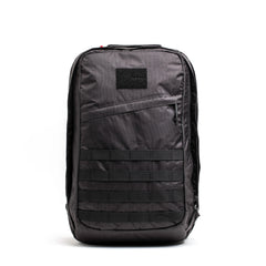 Introducing the GR2 - Dyneema by GORUCK: a stylish black tactical backpack constructed from abrasion-resistant materials. It features multiple compartments with a front patch area and includes horizontal webbing for attachments, side zippers, and a minimalist design ideal for everyday carry.