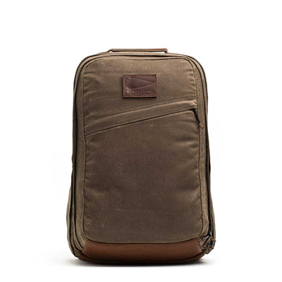 The GR2 - Heritage Waxed Canvas backpack, made from durable brown waxed duck canvas with Red Wing Leather accents and a front zipper pocket, is displayed against a white background.