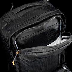 Close-up of durable black GORUCK rucksack with open zippered compartments and mesh organizer panel