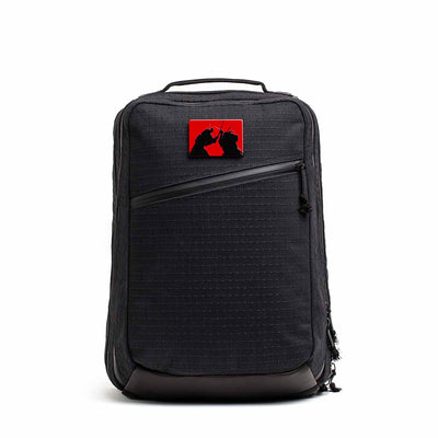 The GR2 x Carryology - GRXC2 Samurai 2.0 is a black backpack with a red patch showing two black cat silhouettes, made from premium JPXDP denim in a special Japan Blue collaboration.