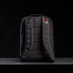 Back view of black GORUCK 26L GR2 Samuari 2.0 durable rucksack with padded straps and stitching on black surface
