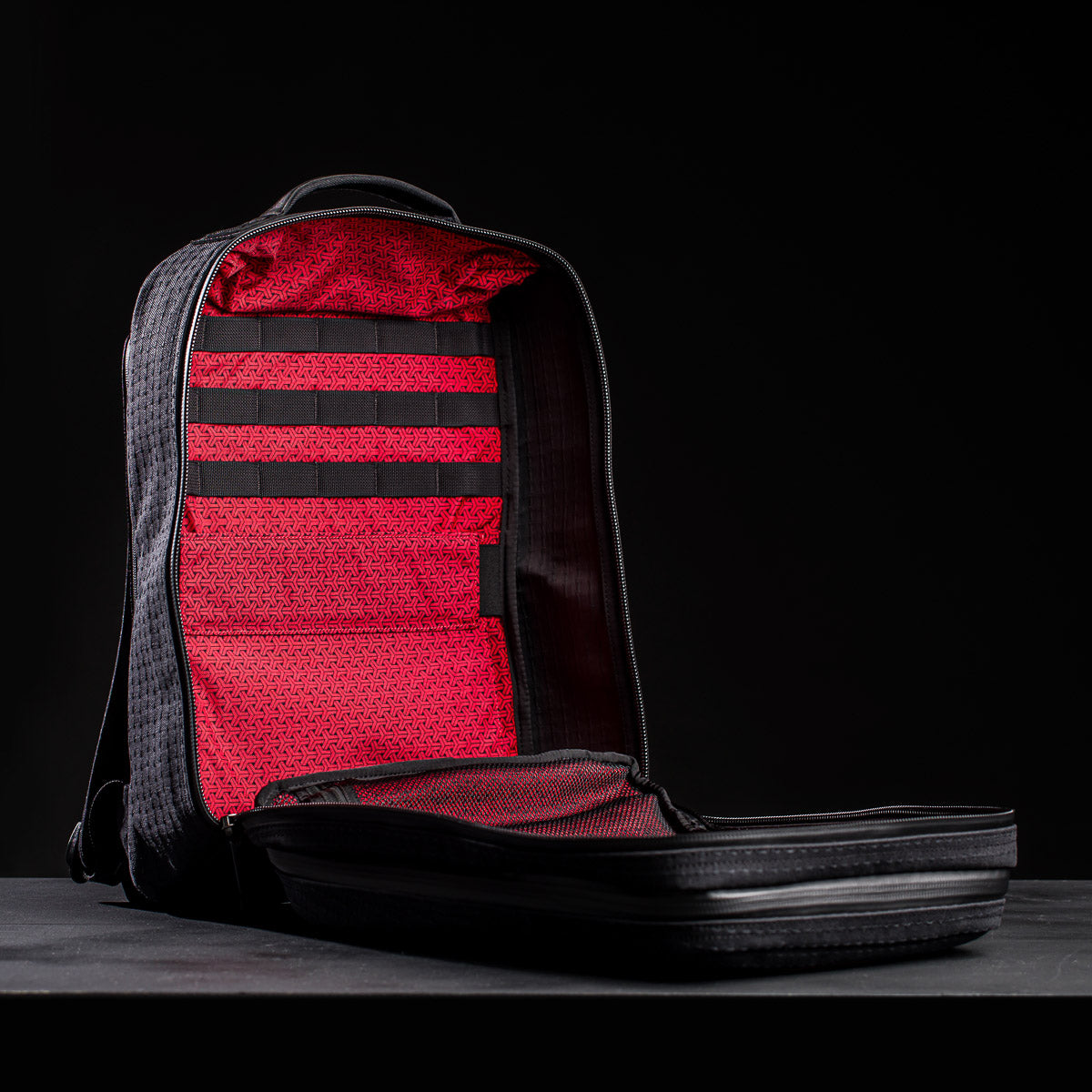 The GR2 x Carryology - GRXC2 Samurai 2.0 features a black Sashiko design with a red interior, open to reveal empty compartments and a laid-flat front flap—a standout piece from the Japan Blue collaboration.