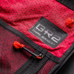 Close-up of GORUCK GR2 26L black backpack interior with red patterned fabric and mesh pockets