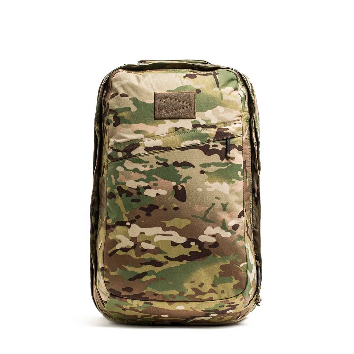 The GR2 X-PAC is a camouflage-patterned backpack made from waterproof X-PAC material, featuring a front zipper pocket with AquaGuard zippers, shown upright against a white background.
