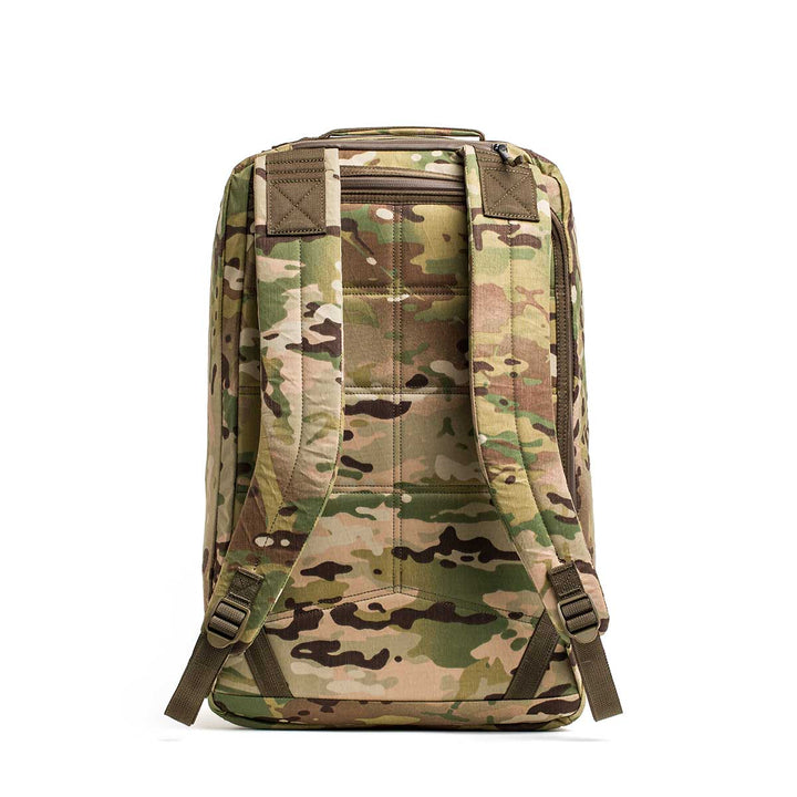 The GR2 X-PAC backpack features a camouflage X-PAC material, padded shoulder straps, and AquaGuard zippers; it's displayed standing upright on a white background.