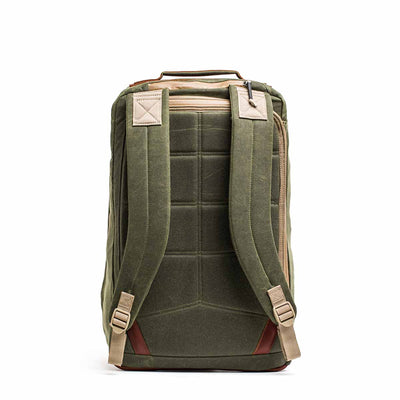The GR2 - Waxed Canvas is an olive green backpack with tan straps, made from durable waxed duck canvas, shown from the back with padded shoulder straps and a top handle.