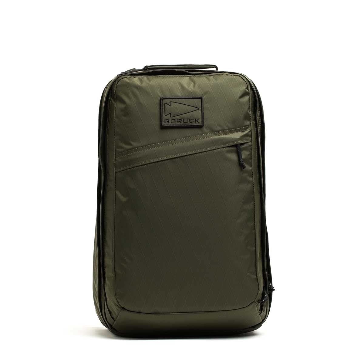 Olive green GR2 X-PAC backpack standing upright, featuring a front zipper pocket with AquaGuard zippers and a top handle.
