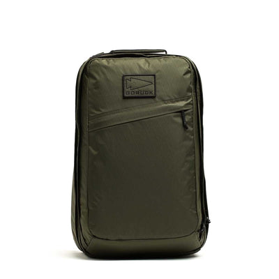 Olive green GR2 X-PAC backpack standing upright, featuring a front zipper pocket with AquaGuard zippers and a top handle.