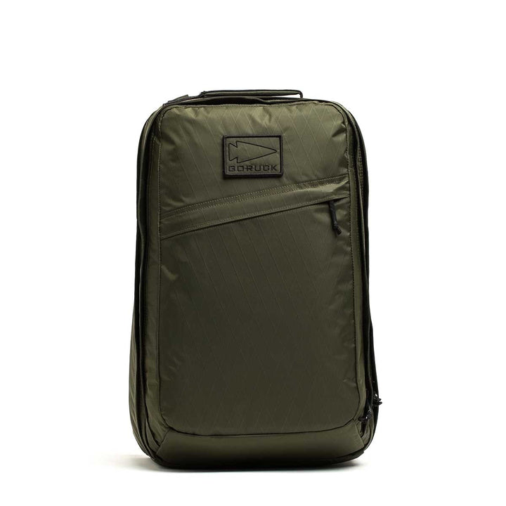 Olive green GR2 X-PAC backpack standing upright, featuring a front zipper pocket with AquaGuard zippers and a top handle.