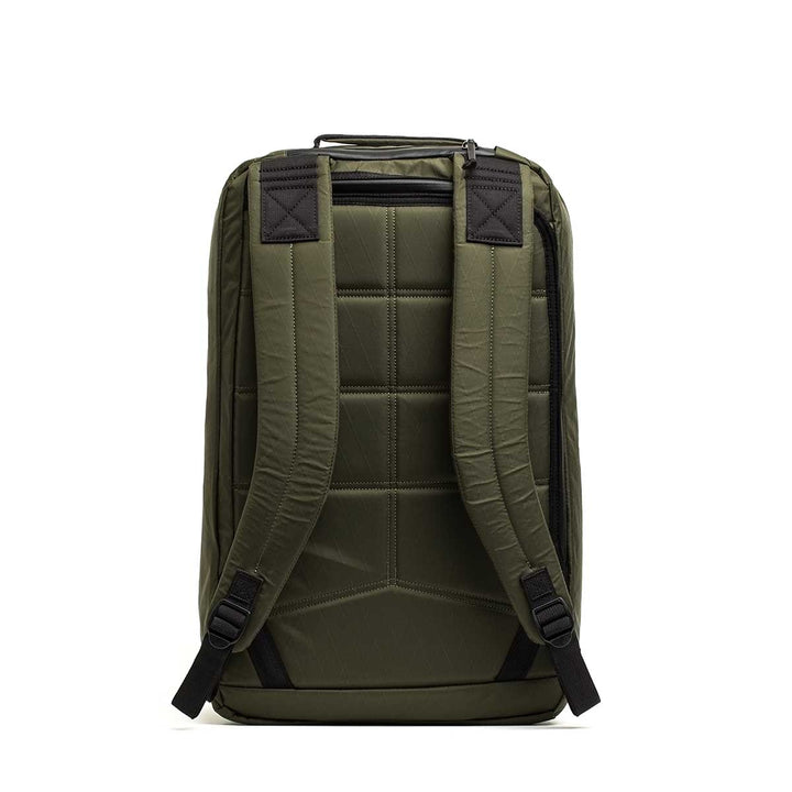 The GR2 X-PAC backpack in olive green is shown from the back, featuring padded straps, a top handle, and waterproof AquaGuard zippers for added protection.