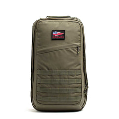 The GR2 USA - Cordura is an olive green tactical travel backpack featuring a front zip pocket and an American flag patch labeled "GORUCK," built for adventure by Special Forces.
