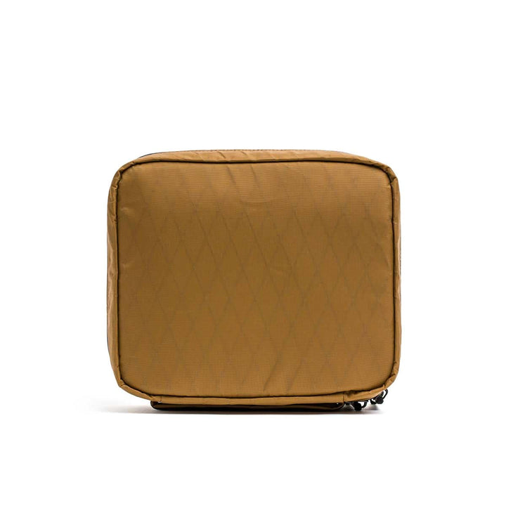 Tan, square-shaped GR2 Field Pocket - X-PAC electronics organizer with diamond-patterned stitching, made from waterproof fabric and featuring AquaGuard zippers. Displayed against a white background.