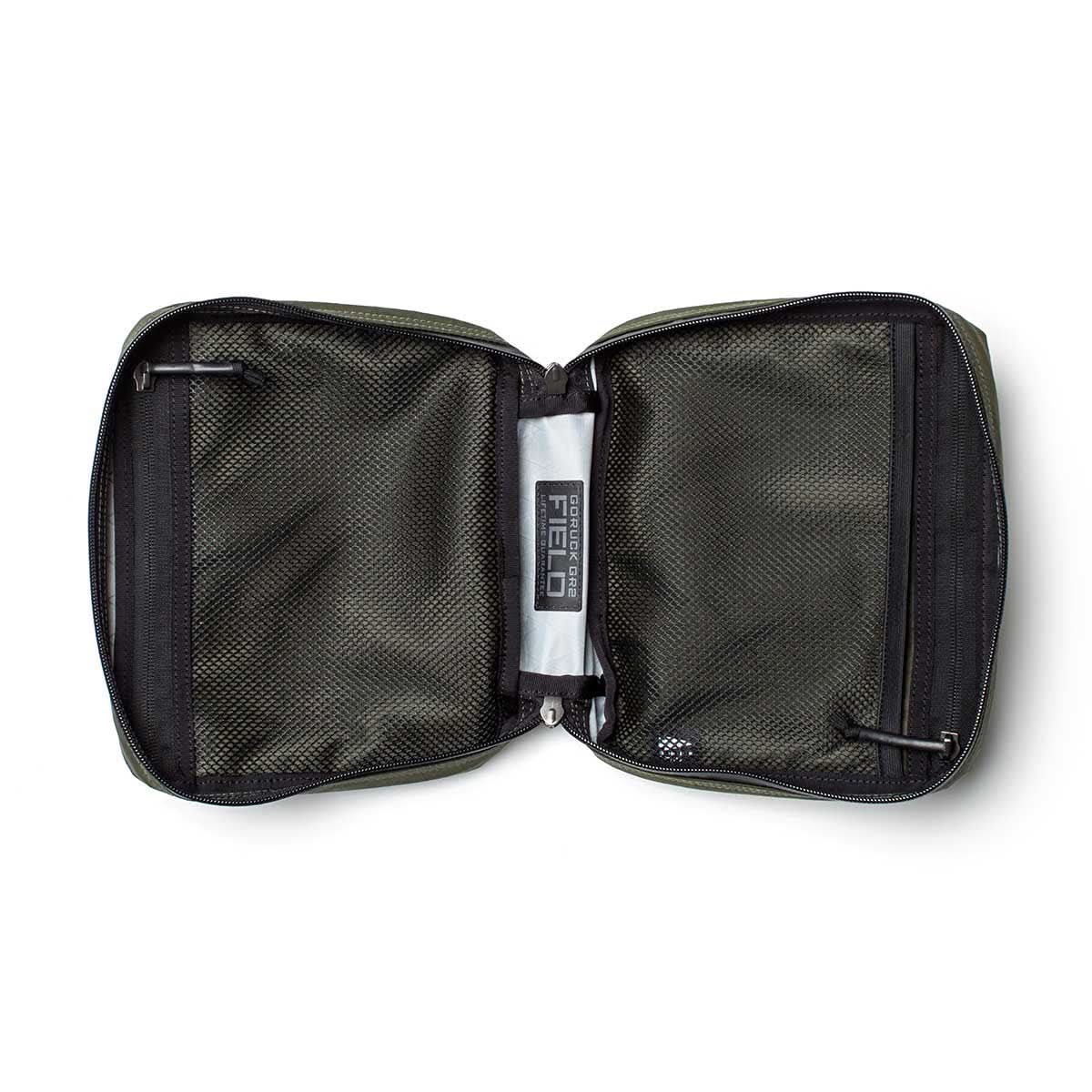 The GR2 Field Pocket - X-PAC is a green zippered pouch with black mesh pockets, a "Field" label inside, and durable waterproof fabric—ideal as an electronics organizer.