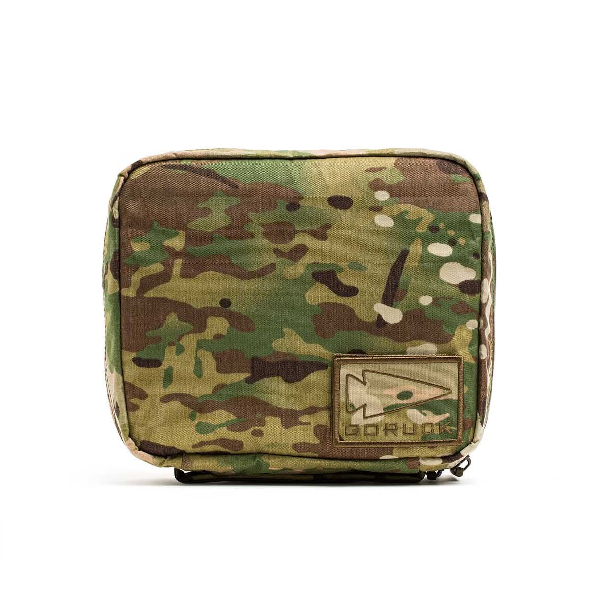 The GR2 Field Pocket - X-PAC is a square camouflage pouch with a Velcro GORUCK patch and fish logo, made from waterproof fabric—ideal for organizing electronics.
