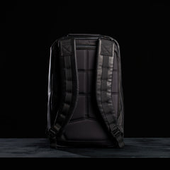 A black GR1 USA x Carryology - Berserker Viking backpack is shown from the back, highlighting its padded straps against a dark background.