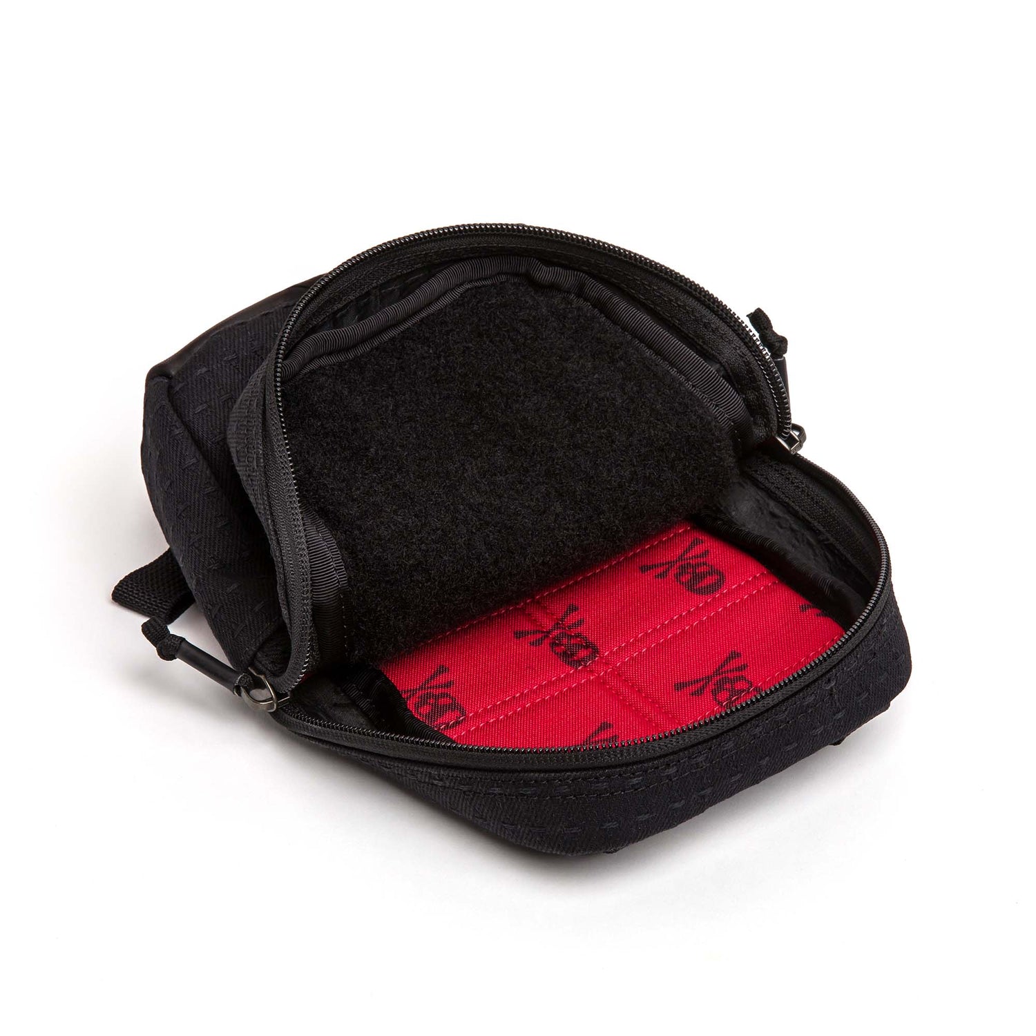 The Japanese Denim GRenade is a small black zippered pouch with waterproof zippers, opening to a red interior lined with black skull and crossbones pattern.