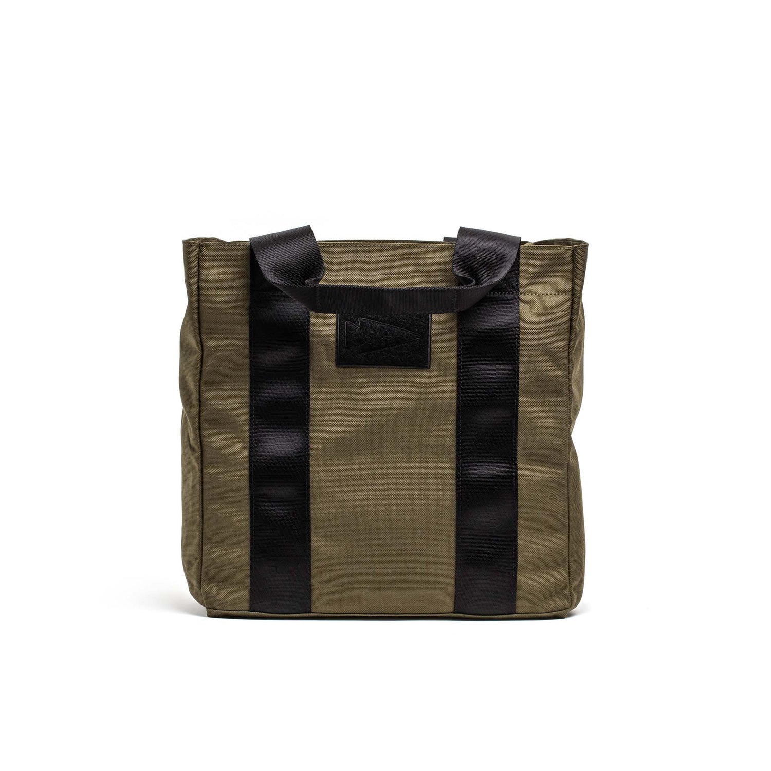 The Grocery Getter, a khaki tote bag by GORUCK, features black vertical straps and handles, is made from tough 1000D Cordura fabric, and is shown on a plain white background.