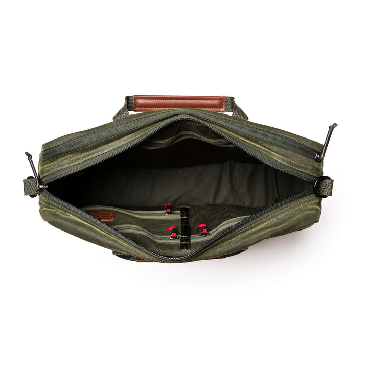 Open olive green GORUCK Shoulder Bag - Waxed Canvas, featuring leather handles, interior pockets, and an asymmetrical design with a Martexin Wax finish, displayed against a white background.