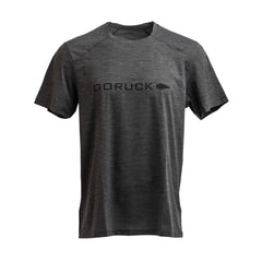 The GORUCK Men’s Performance Tee, made from ToughMesh™ fabric, comes in gray and features the word "GORUCK" and a right-pointing arrow printed in black on the chest. This lightweight training shirt has a straightforward design with short sleeves and a round neck, ideal for adventures ranging from urban environments to the Italian Alps.