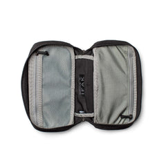 An open black and gray IFAK tactical medical pouch with mesh and fabric compartments lays flat on a white background.