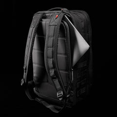 The GR2 - Ballistic Nylon Cordura, a black rucksack with a laptop partly visible in its back compartment, is shown against a black background and built for those seeking Special Forces-level durability.