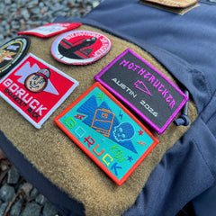 Introducing the KR1 2.0 - Kid Ruck, a durable kids backpack designed for personalization with colorful embroidered patches like “GORUCK” and “MOTHERTRUCKER Austin 2023.”.
