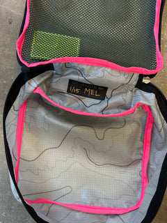 Open gray Ripstop Robic XL Packing Cube with pink trim, mesh pocket, and "SCRUBS 1/15 MEL" label inside—ideal for travel organization and works seamlessly with other packing cubes.