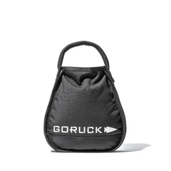A black Sand Kettlebells bag by GORUCK with a handle and white logo, standing upright on a white background.