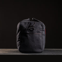 Black GORUCK ruck sack standing upright on dark surface with subtle texture and minimalistic design