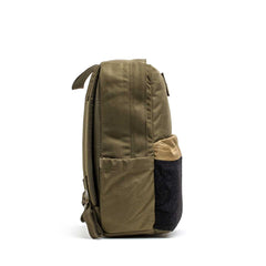 Side view of the KR1 2.0 - Kid Ruck, an olive green kids backpack with tan and black front pocket accents, shown on a white background.