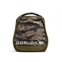 A camouflage GORUCK pouch with a zipper and handle, perfect for carrying Sand Kettlebells, is displayed against a white background.