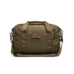 The olive green Kit Bag (Includes Shoulder Strap) is inspired by the classic aviator’s kit bag, featuring handles, a shoulder strap, and a front zipper pocket—ideal for everyday use and rugged adventures.
