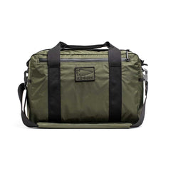 The Kit Bag - X-PAC in olive green features black straps, a front logo patch, and is made from durable X-PAC VX21 fabric, displayed against a white background.