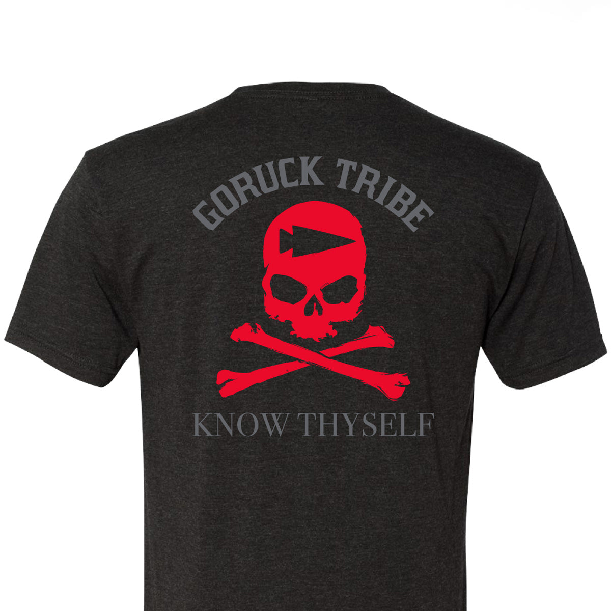 The GORUCK Know Thyself Tribe Tee - Tri-Blend is a black T-shirt with a red skull and crossbones, displaying 