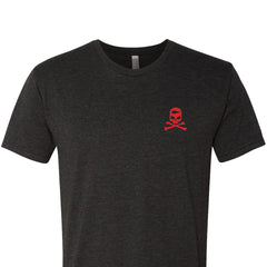 The GORUCK Know Thyself Tribe Tee - Tri-Blend is a dark gray shirt featuring a small red skull and crossbones on the upper left chest, ideal for those taking part in a GORUCK Challenge.